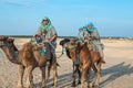 A group of people riding camels in Sahara desert Royalty Free Stock Photo