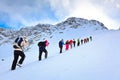 A group of tourists up the hill on snow slope