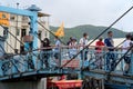 Group of tourists are visiting an old bridge in Tai O, Hong Kong at dragon boat festival Royalty Free Stock Photo