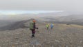 A group of tourists walk through the endless lava fields of Kamchatka