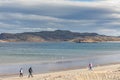 Group of tourists walking along the coast of the Barents Sea