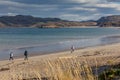 Group of tourists walking along the coast of the Barents Sea