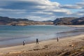 Group of tourists walking along the coast of the Barents Sea