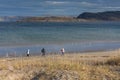 Group of tourists walking along the coast of the Barents Sea