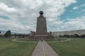 Group of tourists walking around the monument of the Middle of the World near the city of Quito