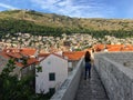 A group of tourists walking the famous walls of Dubrovnik, which encircle the old town of Dubrovnik, Croatia.