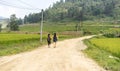 Group of tourists walking on the road in Nepali asian village