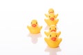 Group of toy rubber ducks in formation with their leader isolated on white