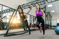 Group training with loops in gym, two young attractive fitness women doing cross fit with straps system. Sport, teamwork, training Royalty Free Stock Photo