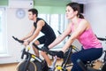 Group training people biking in the gym, exercising legs doing cardio workout cycling bikes Royalty Free Stock Photo