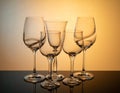 a group of transparent wine glasses on a colored luminous background Royalty Free Stock Photo