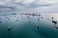 Group of transport ships waiting to carry oil,gas,petrochemicals for export,floating in sea at evening rain strom background