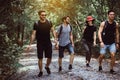 Group of traveler young friends walking and talking together at rain forest,Enjoying backpacking concept Royalty Free Stock Photo