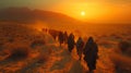 A group of travelers make their way across a vast desert with the scorching sun beating down on them. Despite the Royalty Free Stock Photo