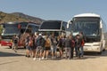 Group of travellers waiting to board their tour bus in Elounda, Crete.