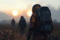Explorers in high-tech exosuits during sunset trek Royalty Free Stock Photo
