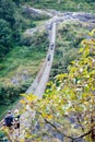 A group of trekkers crossing the bridge in valley with river on Manaslu circuit with view of Mount Manaslu range 8 156 meters. Royalty Free Stock Photo