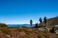 Group of trekkers hikers with backpacks looking at Maramures ridge from Rodna Mountains, Muntii Rodnei National Park, Romania,