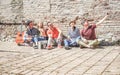 Group of trendy friends taking selfie with mobile cell phone in old historical town center outdoor - Technology mania of new