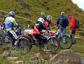 Group of trial motorcycle riders with audience Royalty Free Stock Photo