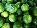 Group of tropical fresh green limes texture background in Thai market