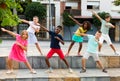 Group of tweenagers performing street dance choreography outdoors