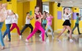 Tweens exercising with coach in choreography class