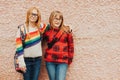 Group of two adorable kid girls with school backpacks wearing glasses