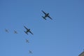 A group of Two Fixed Wing Aircrafts and Four Gray Fighter Aircrafts Going Together Upwards