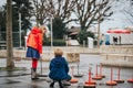 Group of two kids playing giant checkers on playground