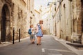 Group of two kids walking on the streets of old european town Royalty Free Stock Photo