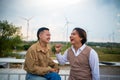 Group of two LGBTQ friends sitting and talking laughing happy on the roof of the coffee shop Royalty Free Stock Photo