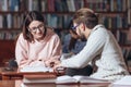 Group of two students studying together at public library Royalty Free Stock Photo