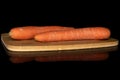 Fresh orange carrot isolated on black glass Royalty Free Stock Photo