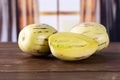 Fresh striped pepino melon with curtains