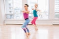 Two young white Caucasian women doing workout in light gym class Royalty Free Stock Photo