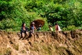 A group of unidentified ethnic children sitting on top of a mountain