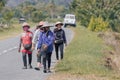 A group of unidentified local famer walking on road side