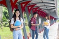 Group of university asian students having fun outdoors,Woman holding many books at university high school campus. Royalty Free Stock Photo