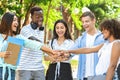 Group Of University Friends Stacking Hands Outdoors After Successful Exams Pass Royalty Free Stock Photo