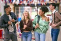 Group Of University Students With Bags Socialising In College Building