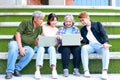 Group of university students of different ages smiling happily using laptop computers to learn. Royalty Free Stock Photo