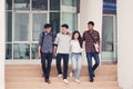 Group of university students walking outside together in campus, Happy Diverse students team concept. Royalty Free Stock Photo