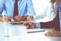 Group of unknown business people discussing questions at meeting in modern office, close-up of hands. Managers at