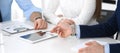 Group of unknown business people discussing questions at meeting in modern office, close-up of hands. Managers at