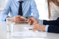 Group of unknown business people discussing questions at meeting in modern office, close-up of hands. Managers at