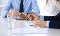 Group of unknown business people discussing questions at meeting in modern office, close-up of hands. Managers at