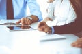 Group of unknown business people discussing questions at meeting in modern office, close-up of hands. Managers at