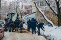 Group of unrecognizable construction workers repairing underground communication cables or pipeline