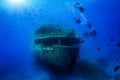 A group of unrecognizable divers explore a sunken shipwreck Royalty Free Stock Photo